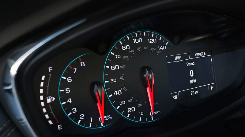 Dashboard of a car featuring a speedometer, displaying speed readings and various control indicators.