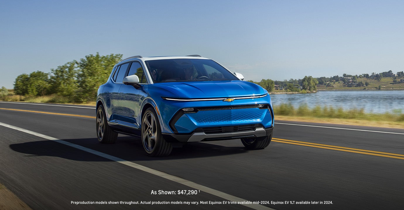 A blue 2024 Chevrolet Equinox EV driving on the road